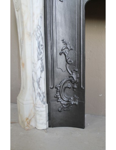 An antique refined Louis XV “Coquille” fireplace mantel in Calacatta Gold marble with its original floral cast-iron insert.