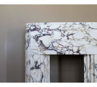 Exceptional Art Deco fireplace mantel in Gold Calacatta Viola marble, featuring violet and gold veins on a white background. 2