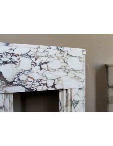 Exceptional Art Deco fireplace mantel in Gold Calacatta Viola marble, featuring violet and gold veins on a white background.