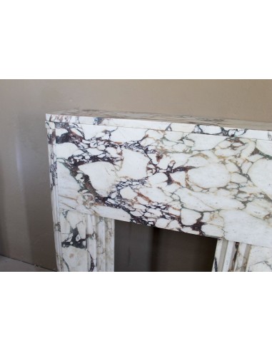 Exceptional Art Deco fireplace mantel in Gold Calacatta Viola marble, featuring violet and gold veins on a white background.