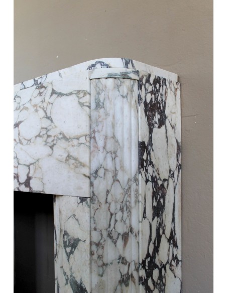 Exceptional Art Deco fireplace mantel in Gold Calacatta Viola marble, featuring violet and gold veins on a white background.