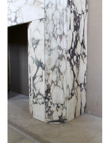 Exceptional Art Deco fireplace mantel in Gold Calacatta Viola marble, featuring violet and gold veins on a white background.