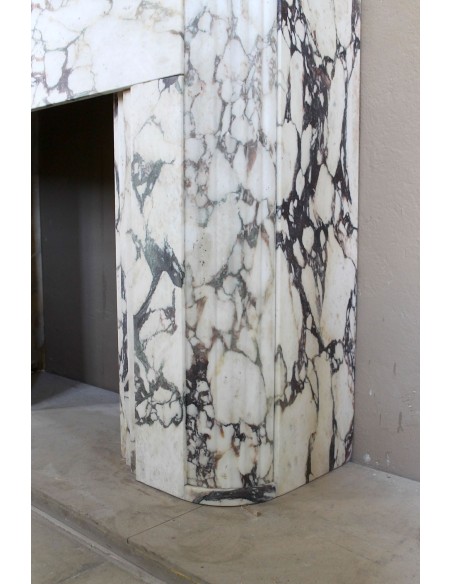 Exceptional Art Deco fireplace mantel in Gold Calacatta Viola marble, featuring violet and gold veins on a white background.