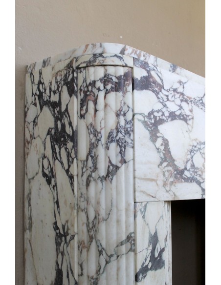 Exceptional Art Deco fireplace mantel in Gold Calacatta Viola marble, featuring violet and gold veins on a white background.