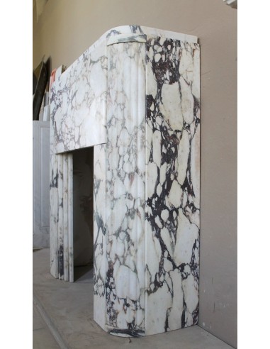 Exceptional Art Deco fireplace mantel in Gold Calacatta Viola marble, featuring violet and gold veins on a white background.