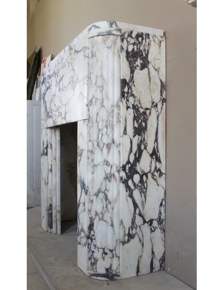 Exceptional Art Deco fireplace mantel in Gold Calacatta Viola marble, featuring violet and gold veins on a white background.