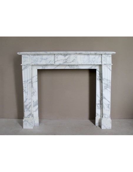 Large antique Neoclassical “Cannelure” fireplace mantel carved in beautifully veined white Arabescato marble.