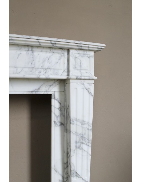 Large antique Neoclassical “Cannelure” fireplace mantel carved in beautifully veined white Arabescato marble.
