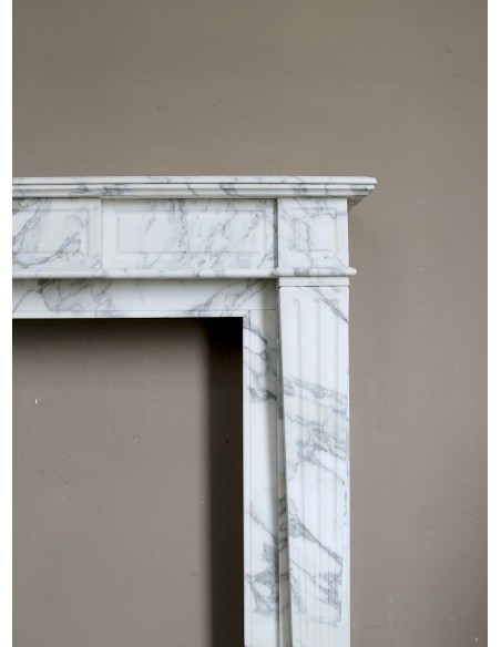 Large antique Neoclassical “Cannelure” fireplace mantel carved in beautifully veined white Arabescato marble.