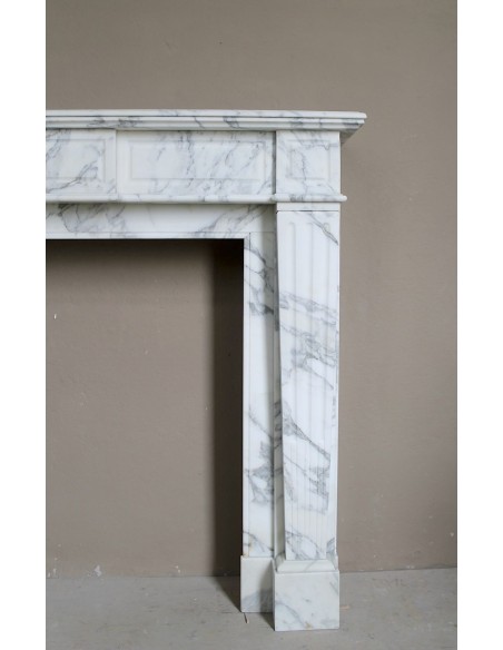 Large antique Neoclassical “Cannelure” fireplace mantel carved in beautifully veined white Arabescato marble.
