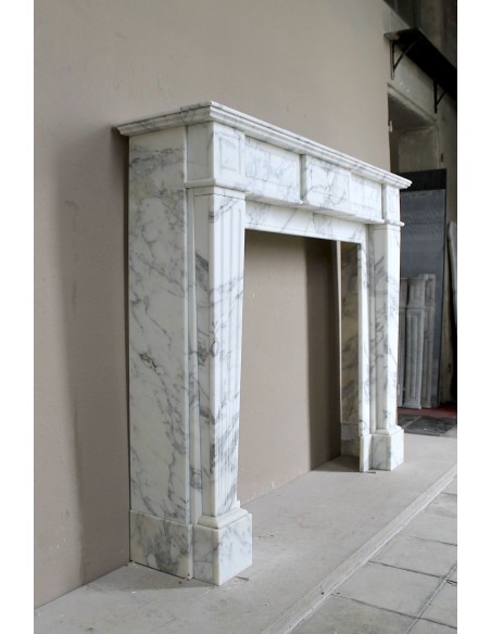 Large antique Neoclassical “Cannelure” fireplace mantel carved in beautifully veined white Arabescato marble.