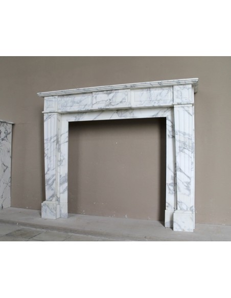 Large antique Neoclassical “Cannelure” fireplace mantel carved in beautifully veined white Arabescato marble.