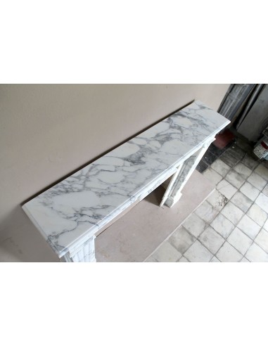 Large antique Neoclassical “Cannelure” fireplace mantel carved in beautifully veined white Arabescato marble.