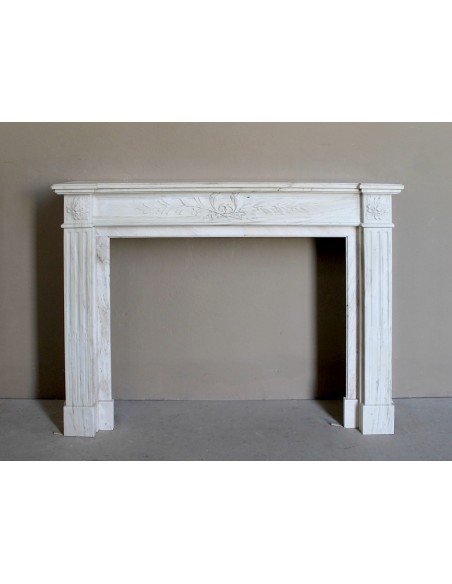 Antique Neoclassical fireplace mantel with olive branch decoration in Cremo Delicato marble, offered at a discounted price.