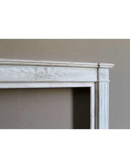 Antique Neoclassical fireplace mantel with olive branch decoration in Cremo Delicato marble, offered at a discounted price.
