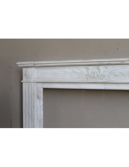 Antique Neoclassical fireplace mantel with olive branch decoration in Cremo Delicato marble, offered at a discounted price.