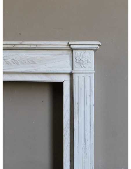 Antique Neoclassical fireplace mantel with olive branch decoration in Cremo Delicato marble, offered at a discounted price.
