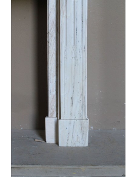 Antique Neoclassical fireplace mantel with olive branch decoration in Cremo Delicato marble, offered at a discounted price.