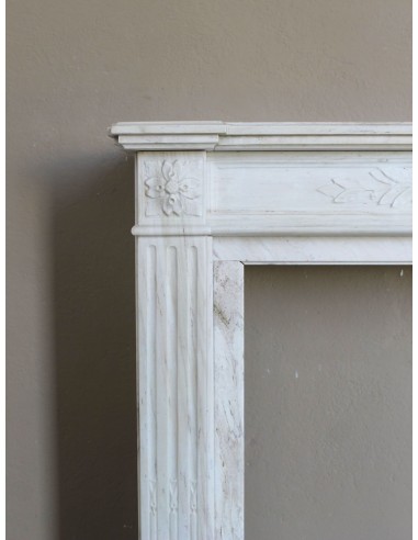 Antique Neoclassical fireplace mantel with olive branch decoration in Cremo Delicato marble, offered at a discounted price.