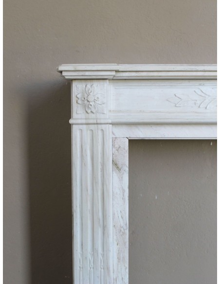 Antique Neoclassical fireplace mantel with olive branch decoration in Cremo Delicato marble, offered at a discounted price.