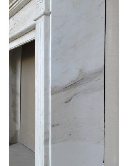 Antique Neoclassical fireplace mantel with olive branch decoration in Cremo Delicato marble, offered at a discounted price.