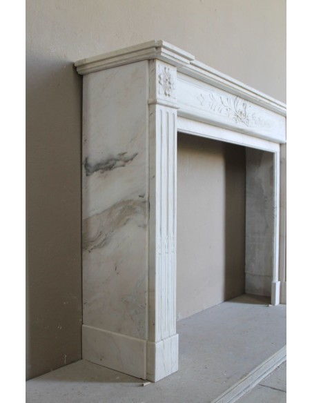 Antique Neoclassical fireplace mantel with olive branch decoration in Cremo Delicato marble, offered at a discounted price.