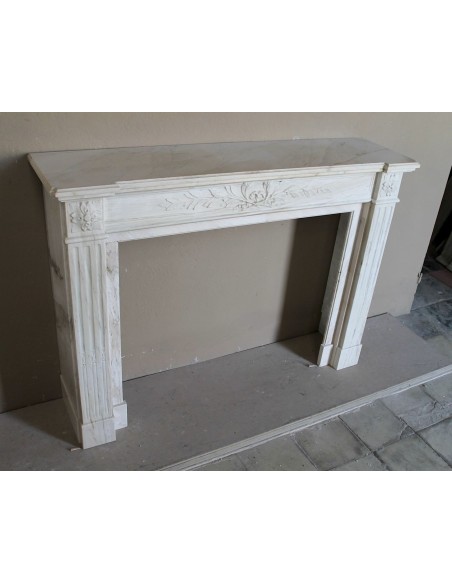 Antique Neoclassical fireplace mantel with olive branch decoration in Cremo Delicato marble, offered at a discounted price.