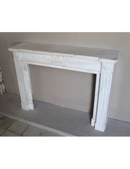Antique Neoclassical fireplace mantel with olive branch decoration in Cremo Delicato marble, offered at a discounted price.