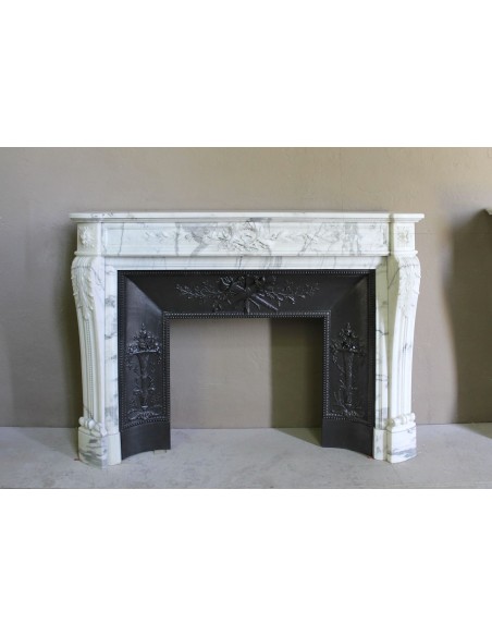 Antique Neoclassical “Olive Branch” fireplace, finely carved in Arabescato white marble and with its original cast-iron insert.