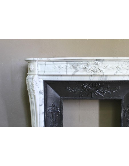Antique Neoclassical “Olive Branch” fireplace, finely carved in Arabescato white marble and with its original cast-iron insert.