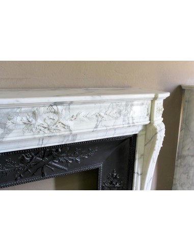 Antique Neoclassical “Olive Branch” fireplace, finely carved in Arabescato white marble and with its original cast-iron insert.
