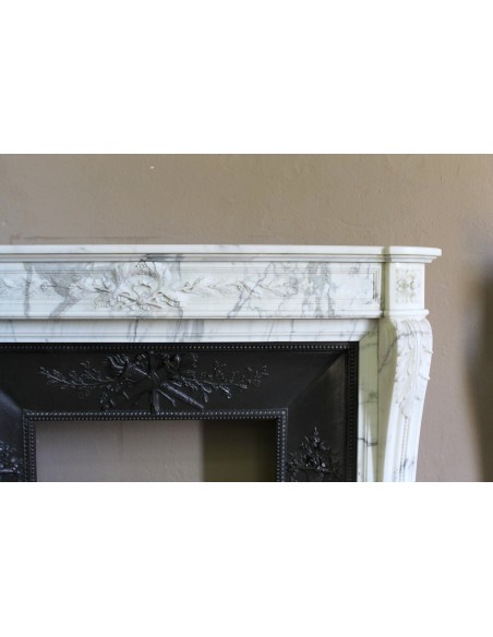 Antique Neoclassical “Olive Branch” fireplace, finely carved in Arabescato white marble and with its original cast-iron insert.