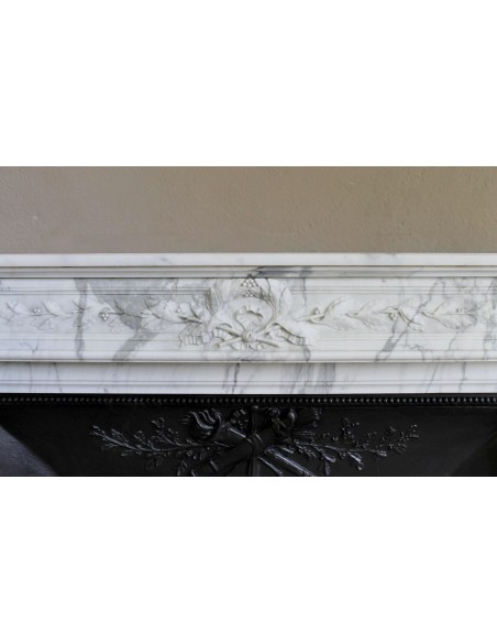 Antique Neoclassical “Olive Branch” fireplace, finely carved in Arabescato white marble and with its original cast-iron insert.