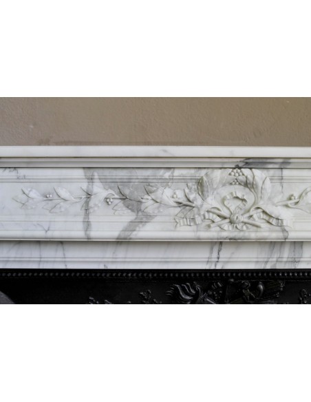 Antique Neoclassical “Olive Branch” fireplace, finely carved in Arabescato white marble and with its original cast-iron insert.
