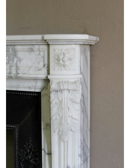 Antique Neoclassical “Olive Branch” fireplace, finely carved in Arabescato white marble and with its original cast-iron insert.