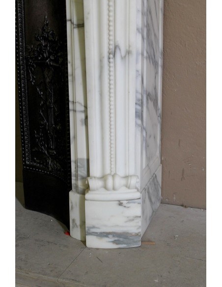 Antique Neoclassical “Olive Branch” fireplace, finely carved in Arabescato white marble and with its original cast-iron insert.