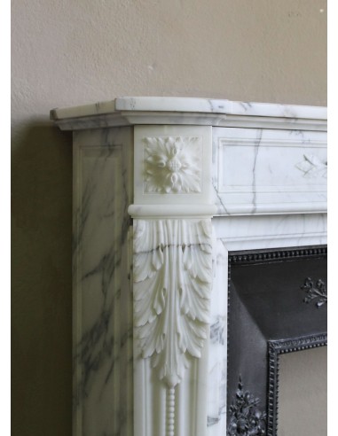 Antique Neoclassical “Olive Branch” fireplace, finely carved in Arabescato white marble and with its original cast-iron insert.