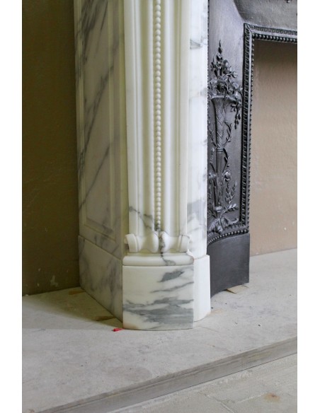 Antique Neoclassical “Olive Branch” fireplace, finely carved in Arabescato white marble and with its original cast-iron insert.