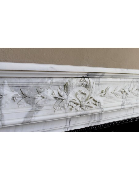 Antique Neoclassical “Olive Branch” fireplace, finely carved in Arabescato white marble and with its original cast-iron insert.