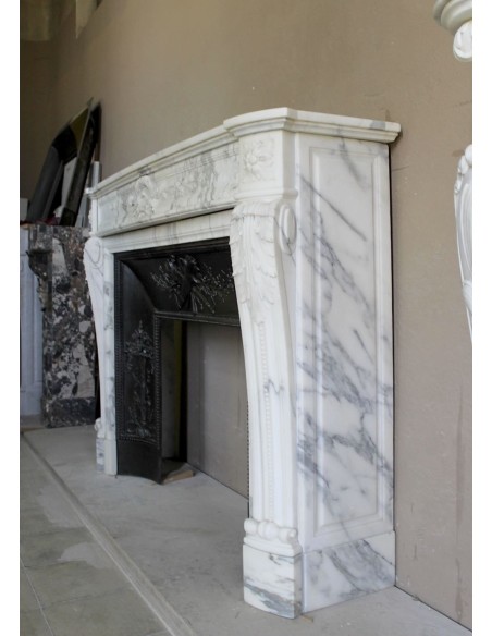 Antique Neoclassical “Olive Branch” fireplace, finely carved in Arabescato white marble and with its original cast-iron insert.