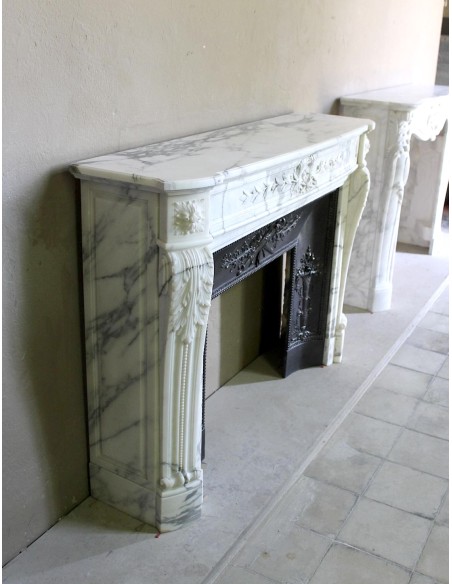 Antique Neoclassical “Olive Branch” fireplace, finely carved in Arabescato white marble and with its original cast-iron insert.