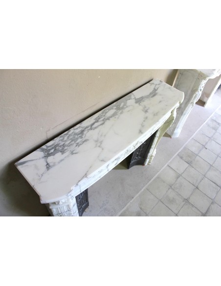 Antique Neoclassical “Olive Branch” fireplace, finely carved in Arabescato white marble and with its original cast-iron insert.