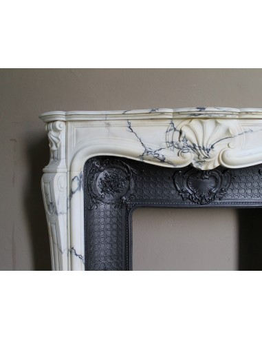 Important antique Louis XV “Coquille Bordelaise” fireplace mantel in rare Pavonazzo marble, with its original cast-iron insert.