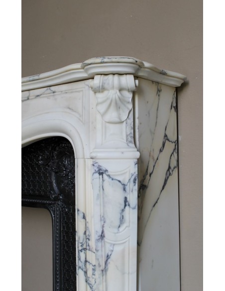 Important antique Louis XV “Coquille Bordelaise” fireplace mantel in rare Pavonazzo marble, with its original cast-iron insert.