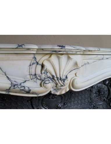 Important antique Louis XV “Coquille Bordelaise” fireplace mantel in rare Pavonazzo marble, with its original cast-iron insert.