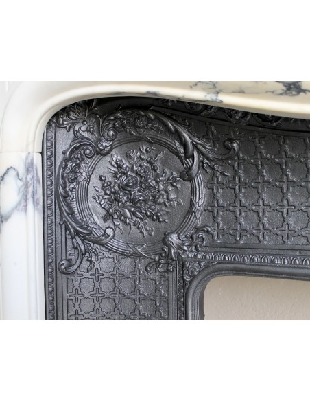 Important antique Louis XV “Coquille Bordelaise” fireplace mantel in rare Pavonazzo marble, with its original cast-iron insert.
