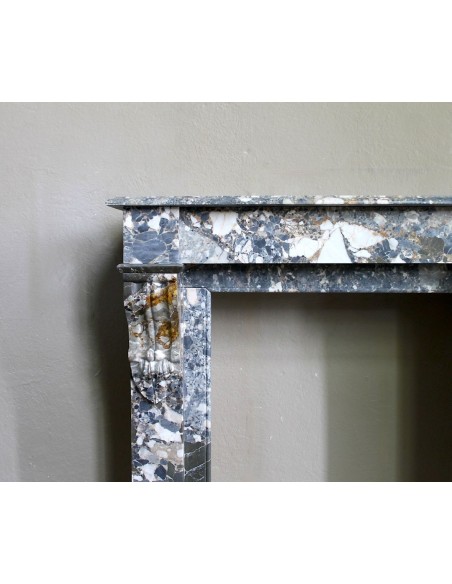 Antique “Palmettes” fireplace in a charmingly compact size, carved in Black marble with richly varied multicoloured veining.