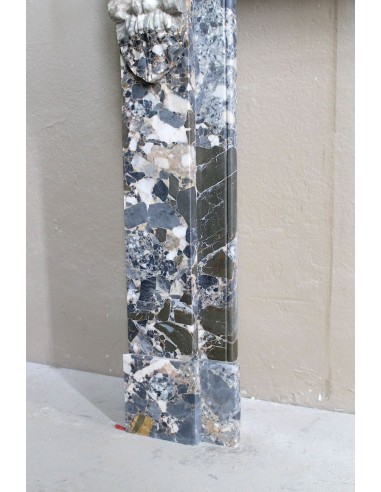 Antique “Palmettes” fireplace in a charmingly compact size, carved in Black marble with richly varied multicoloured veining.