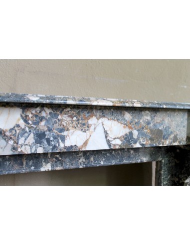 Antique “Palmettes” fireplace in a charmingly compact size, carved in Black marble with richly varied multicoloured veining.
