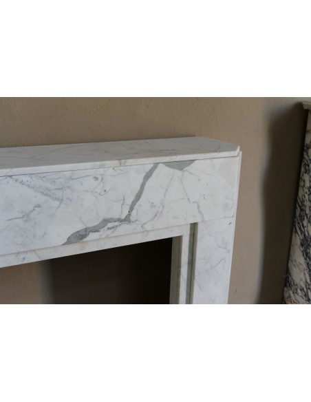 Beautiful antique Art Deco-style fireplace mantel carved in White veined Carrara marble.
